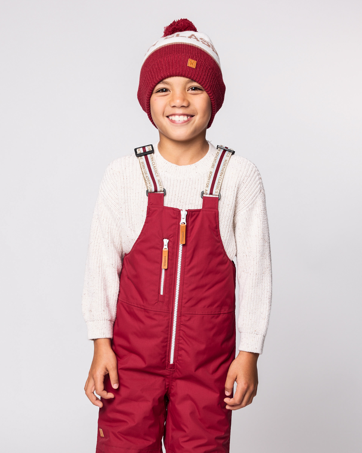 Classic Knit Pom Pom Hat for Kids and Women’s sizes in red, brown, and white, crafted with soft knit fabric, luxe faux fur pom detail, and winter-ready durability for everyday adventures. It's so soft it feels like cashmere.