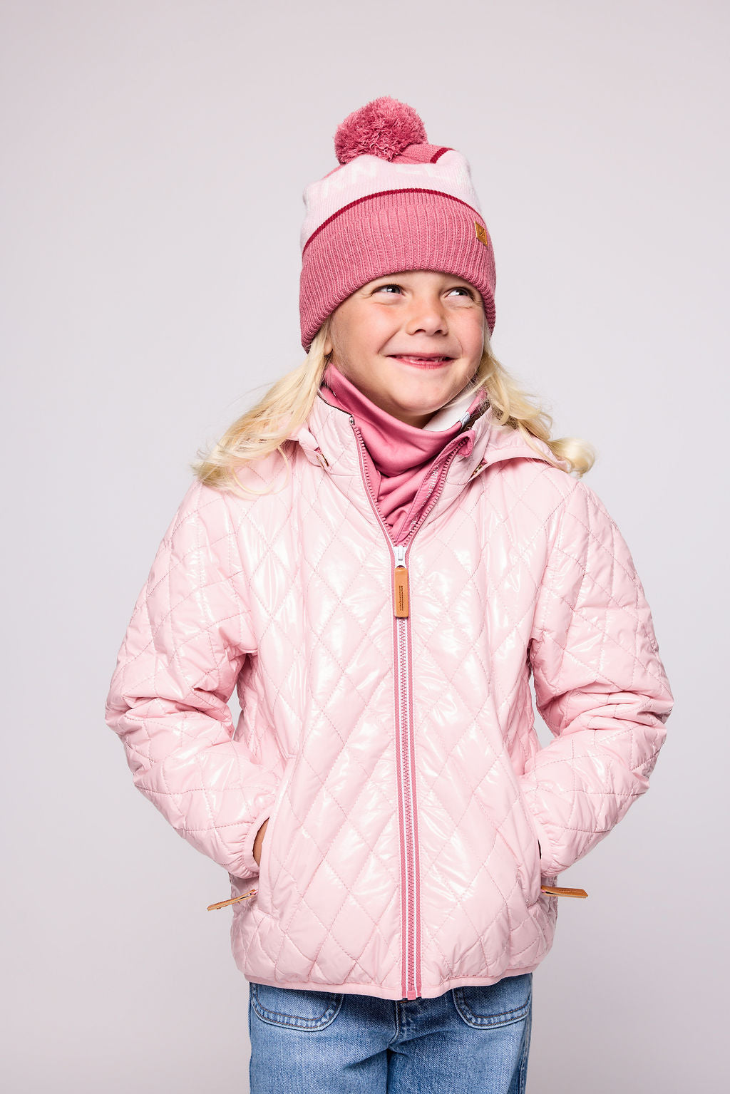 Girls and women shiny light pink puffer jacket for fall and winter, designed as a warm in-between layer with removable hood, insulated core, and water-resistant fabric