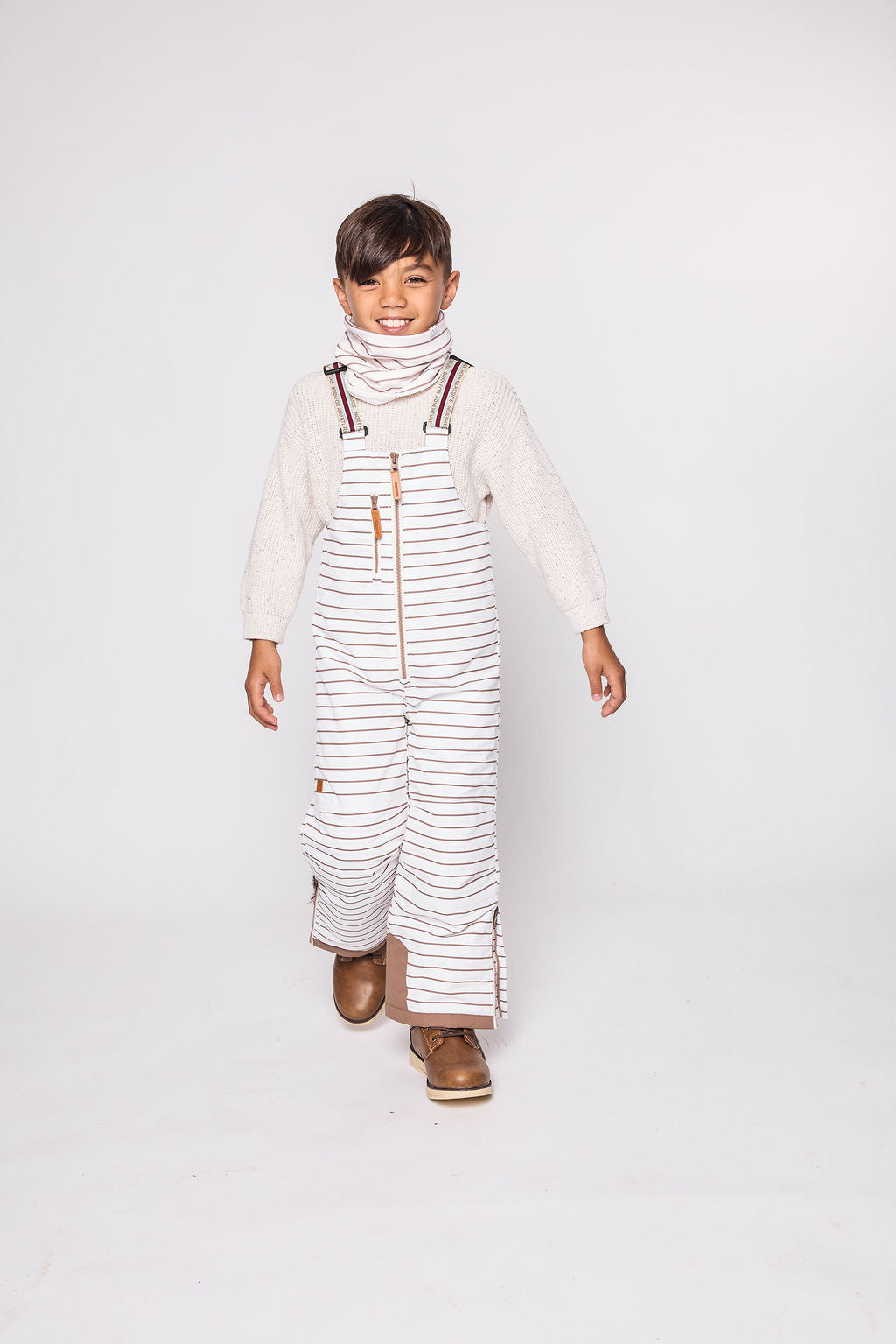 Kids striped brown and white snow bib pants with adjustable straps, waterproof fabric, and reinforced knees for winter play