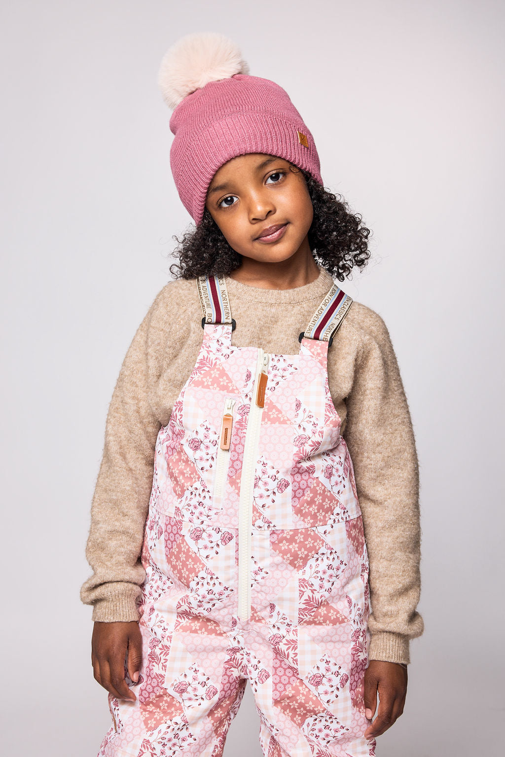Kids light pink patchwork snow bib pants with adjustable straps, waterproof fabric, and reinforced knees for winter play and ski for girls