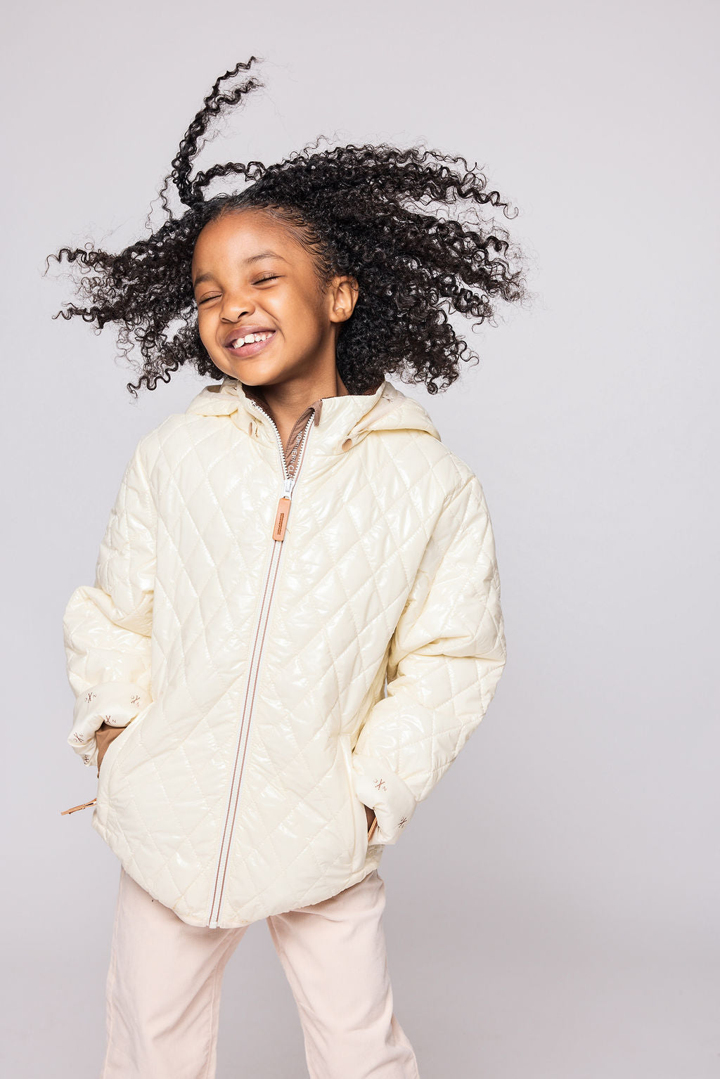 Kids and women shiny white puffer jacket for fall and winter, designed as a warm in-between layer with removable hood, insulated core, and water-resistant fabric