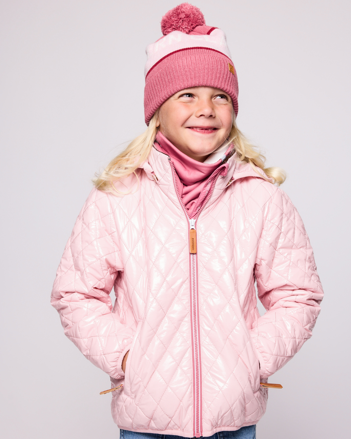 Kids and women's pink fleece neck warmer for boys and girls, made with soft, breathable fabric to keep necks warm during outdoor play, skiing, and winter snow activities