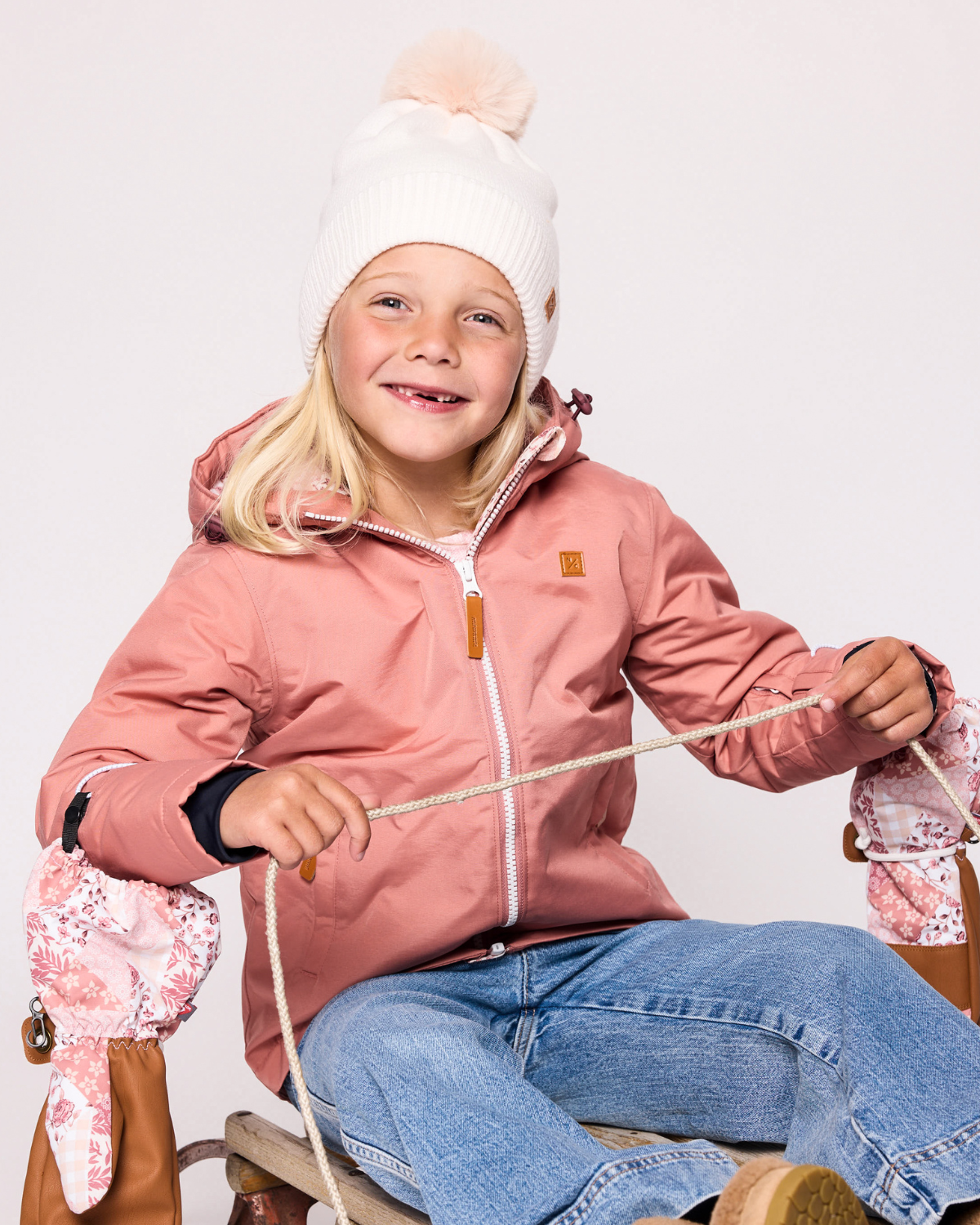 Classic Knit Pom Pom Hat for Kids and Women’s sizes in beige white crafted with soft knit fabric, luxe faux fur pom detail, and winter-ready durability for everyday adventures. It's so soft it feels like cashmere.