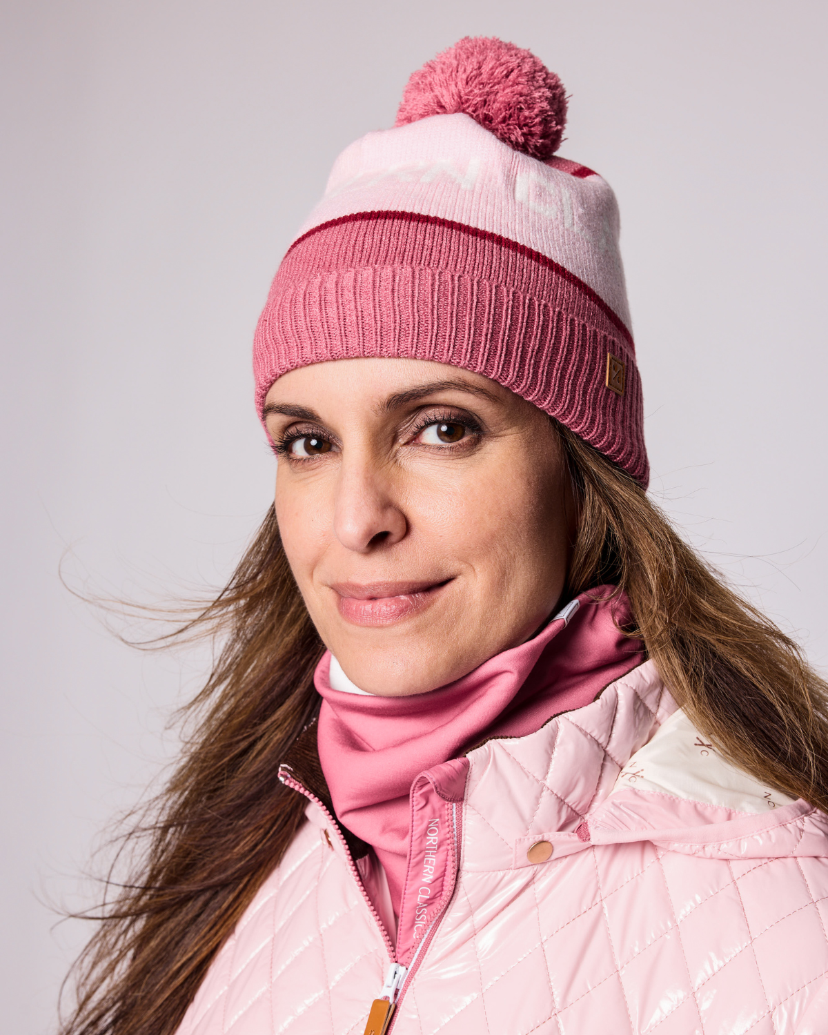 Classic Knit Pom Pom Hat for Kids and Women’s sizes in rose pink, light pink, and red, crafted with soft knit fabric, luxe faux fur pom detail, and winter-ready durability for everyday adventures. It's so soft it feels like cashmere.