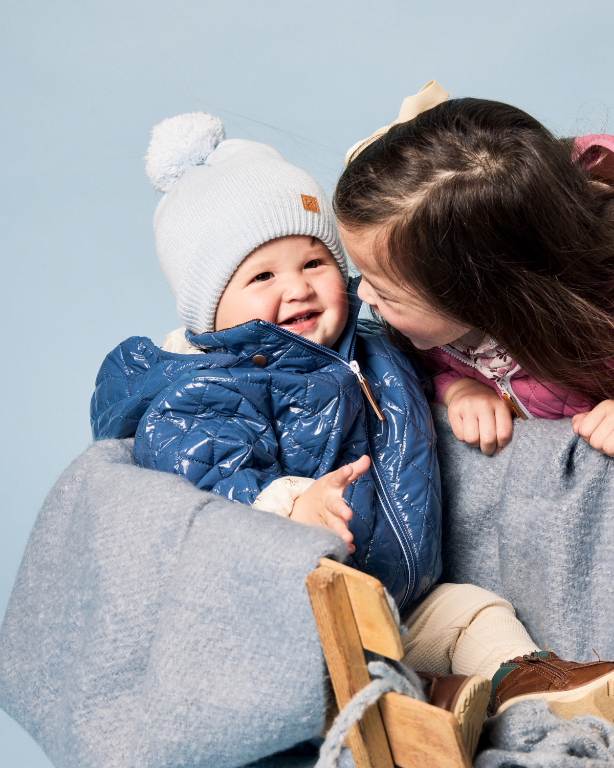 Classic Knit Pom Pom Hat for Kids and Women’s sizes in light blue crafted with soft knit fabric, luxe faux fur pom detail, and winter-ready durability for everyday adventures. It's so soft it feels like cashmere.