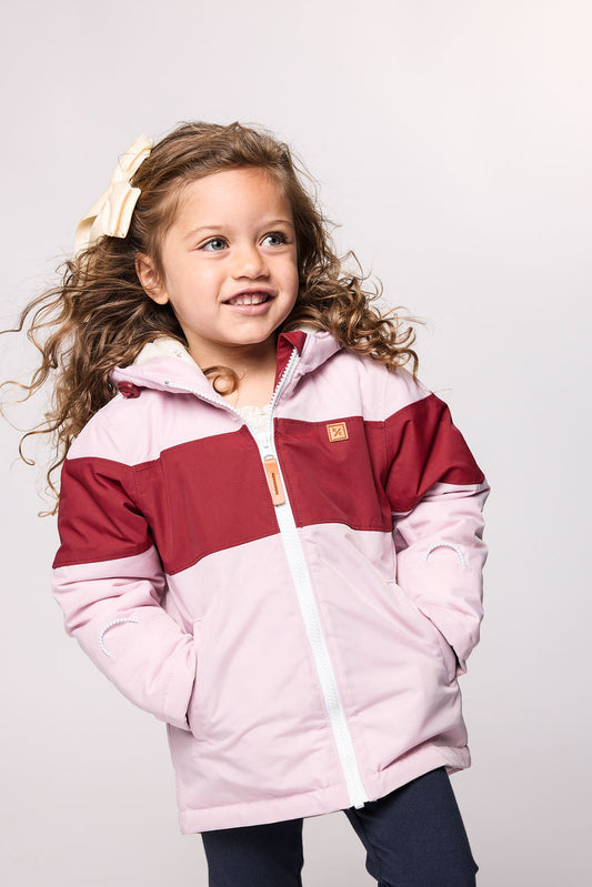 Kids red and light pink winter coat for skiing and snow play, with warm insulation and waterproof outer shell for full cold weather protection and hood