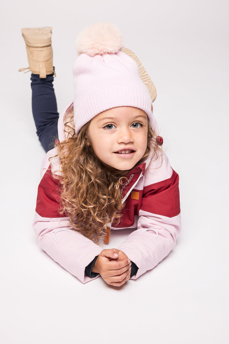 Kids red and light pink winter coat for skiing and snow play, with warm insulation and waterproof outer shell for full cold weather protection and hood