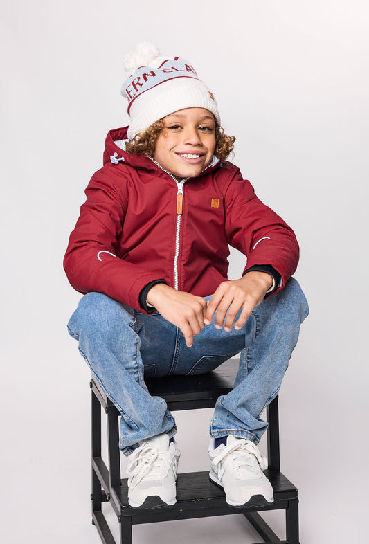 Kids red winter coat for skiing and snow play, with warm insulation and waterproof outer shell for full cold weather protection and hood