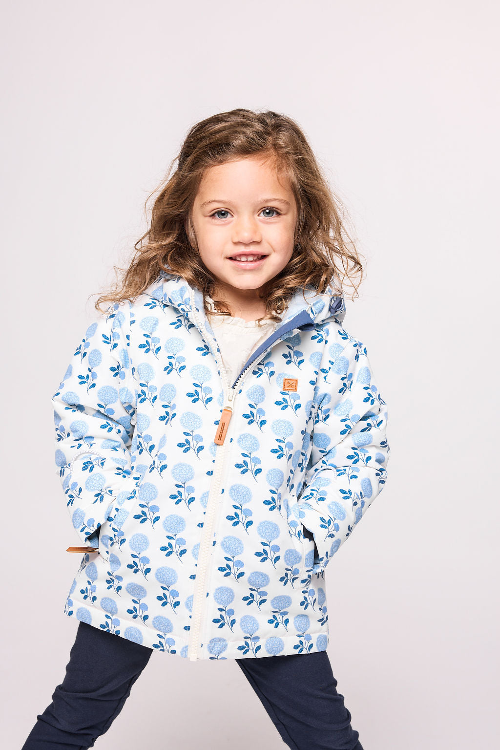 Girls and women blue floral hydrangea winter coat for skiing and snow play, with warm insulation and waterproof outer shell for full cold weather protection
