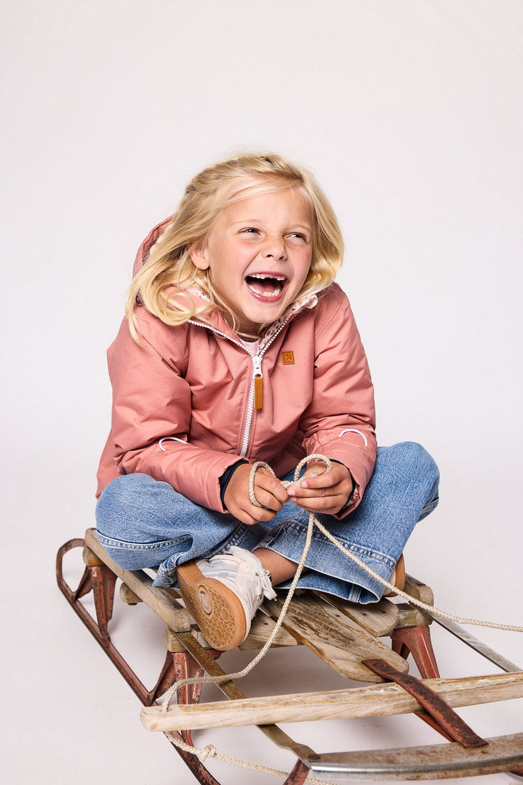 Girls pink winter coat for skiing and snow play, with warm insulation and waterproof outer shell for full cold weather protection and hood