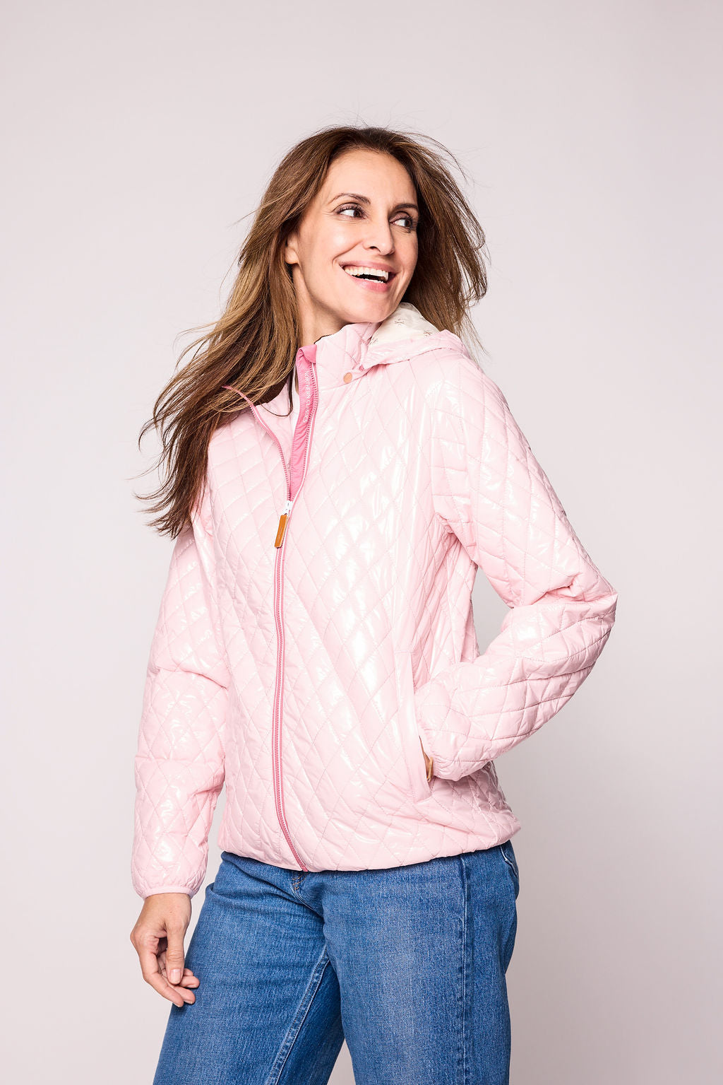 Women's shiny pink puffer jacket for fall and winter with removable hood, insulated lining, and water-resistant outer shell