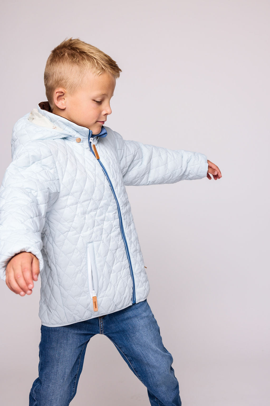 Kids and women light blue puffer jacket for fall and winter, designed as a warm in-between layer with removable hood, insulated core, and water-resistant fabric