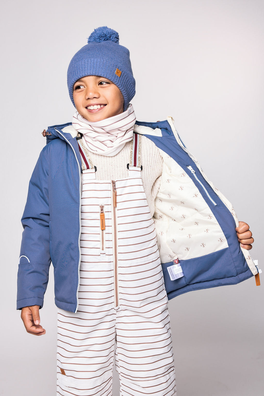Kids blue winter coat for skiing and snow play, with warm insulation and waterproof outer shell for full cold weather protection and hood
