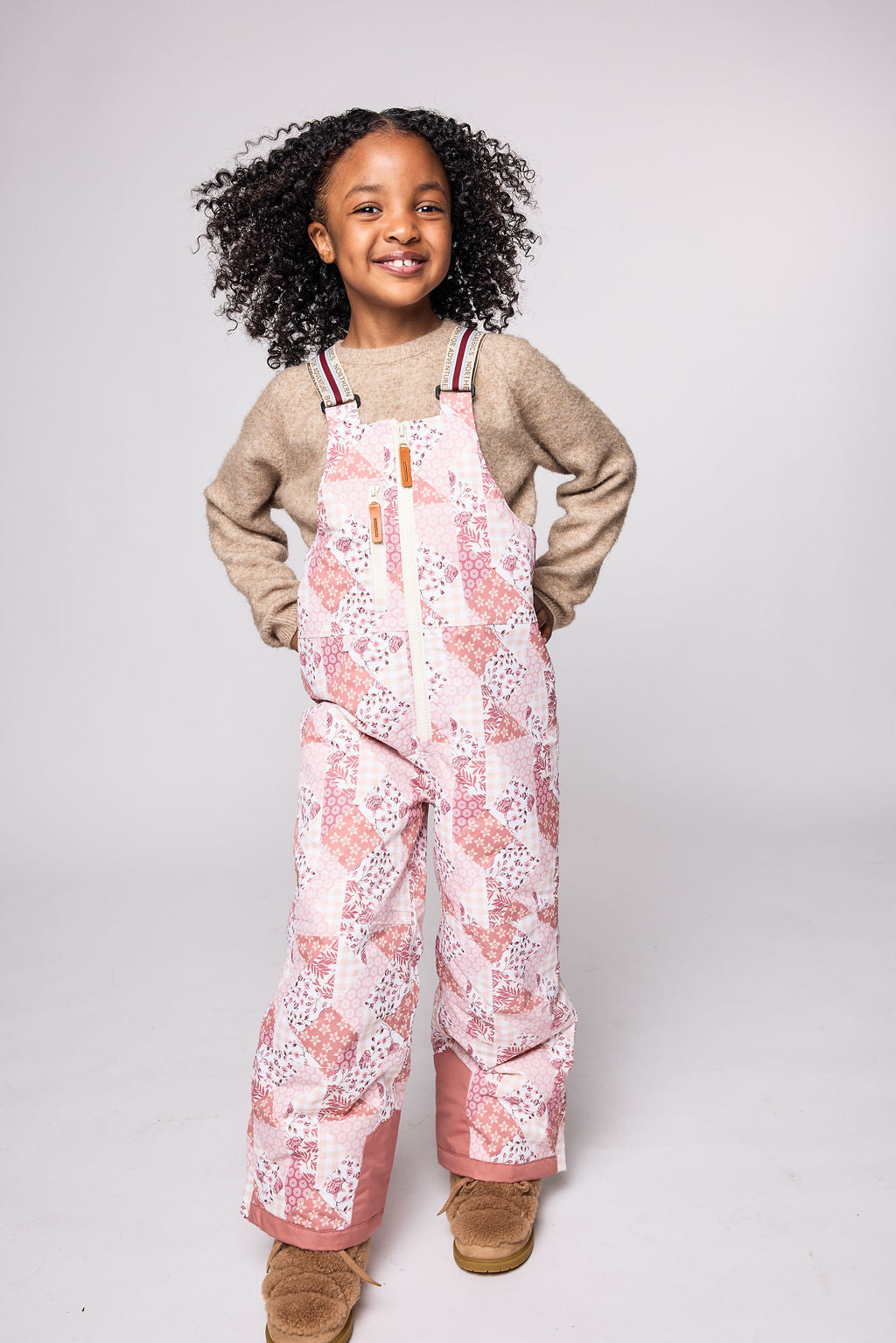 Kids light pink patchwork snow bib pants with adjustable straps, waterproof fabric, and reinforced knees for winter play and ski for girls