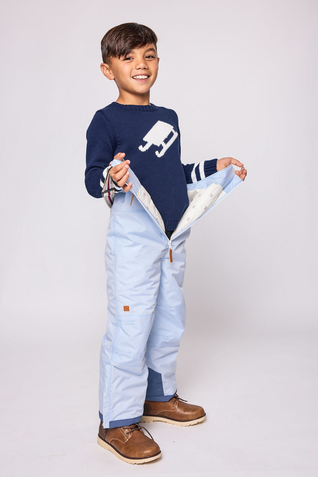 Kids light blue snow bib pants with adjustable straps, waterproof fabric, and reinforced knees for winter play and ski