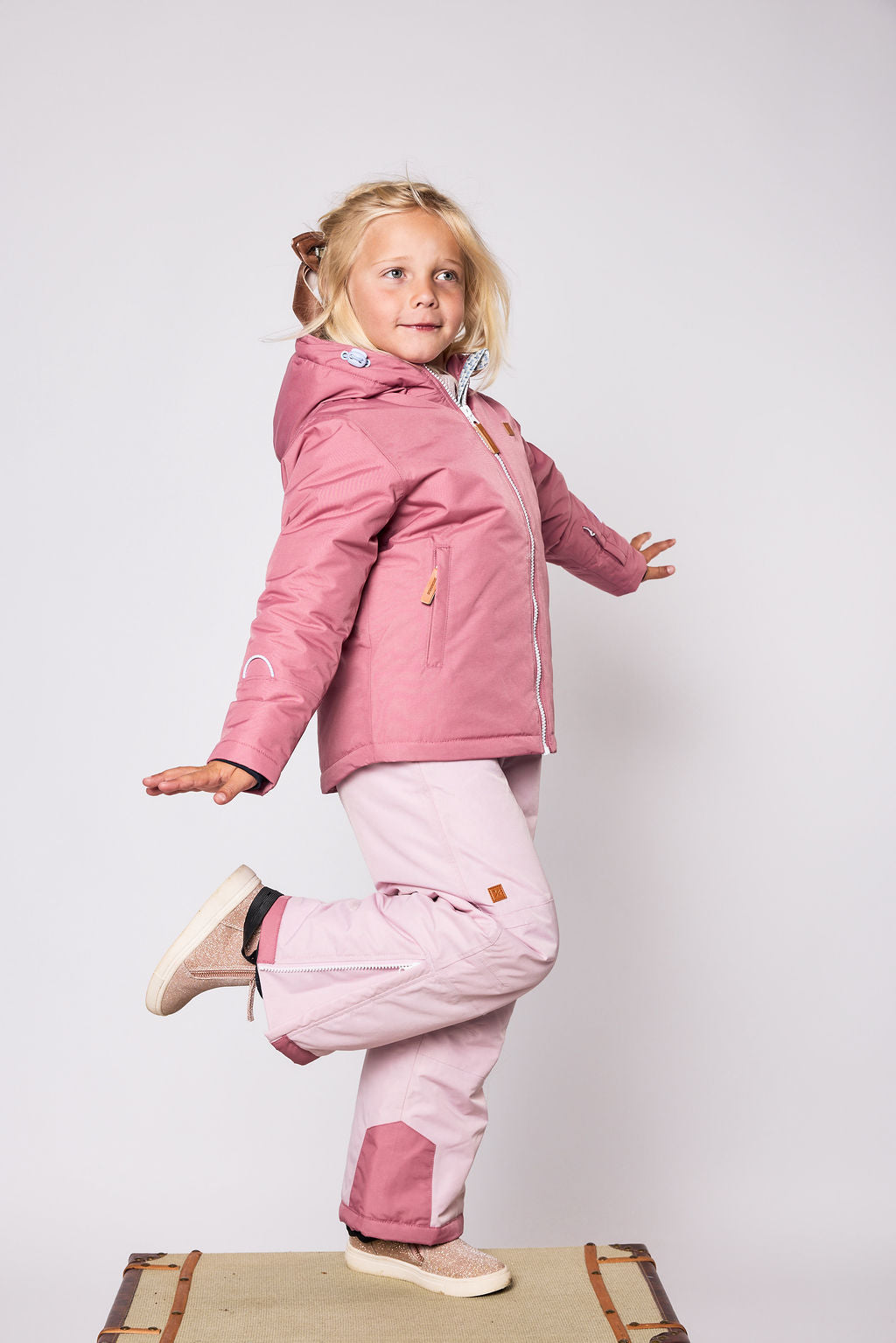 Girls pink winter coat for skiing and snow play, with warm insulation and waterproof outer shell for full cold weather protection and hood