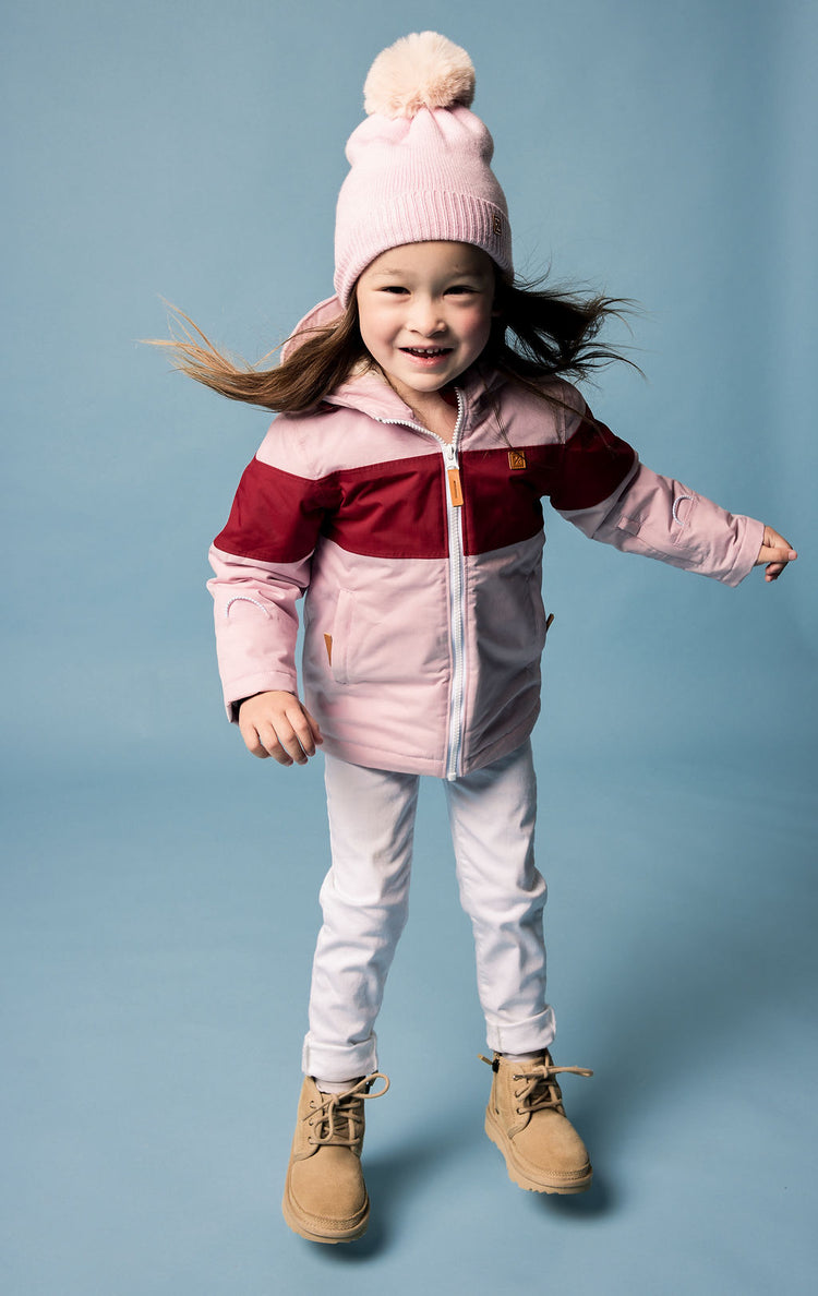 Kids red and light pink winter coat for skiing and snow play, with warm insulation and waterproof outer shell for full cold weather protection and hood