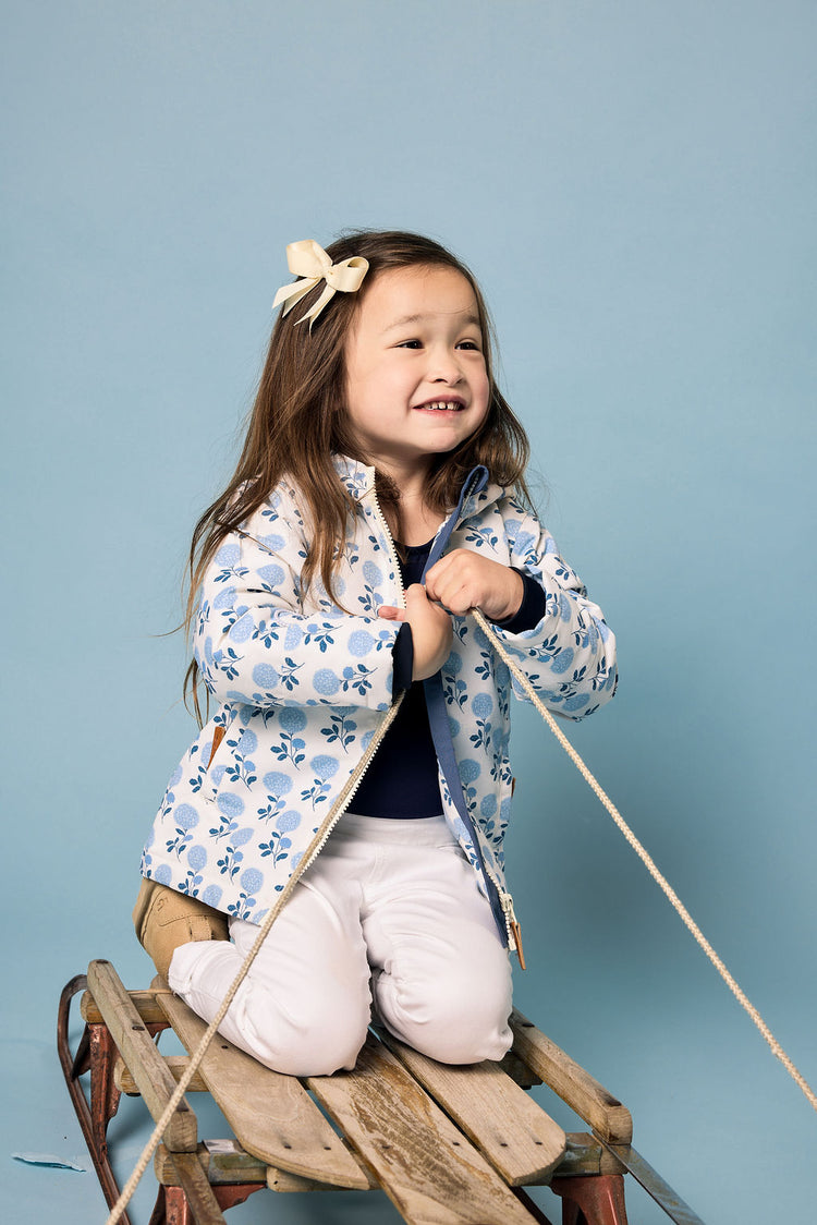 Girls and women blue floral hydrangea winter coat for skiing and snow play, with warm insulation and waterproof outer shell for full cold weather protection