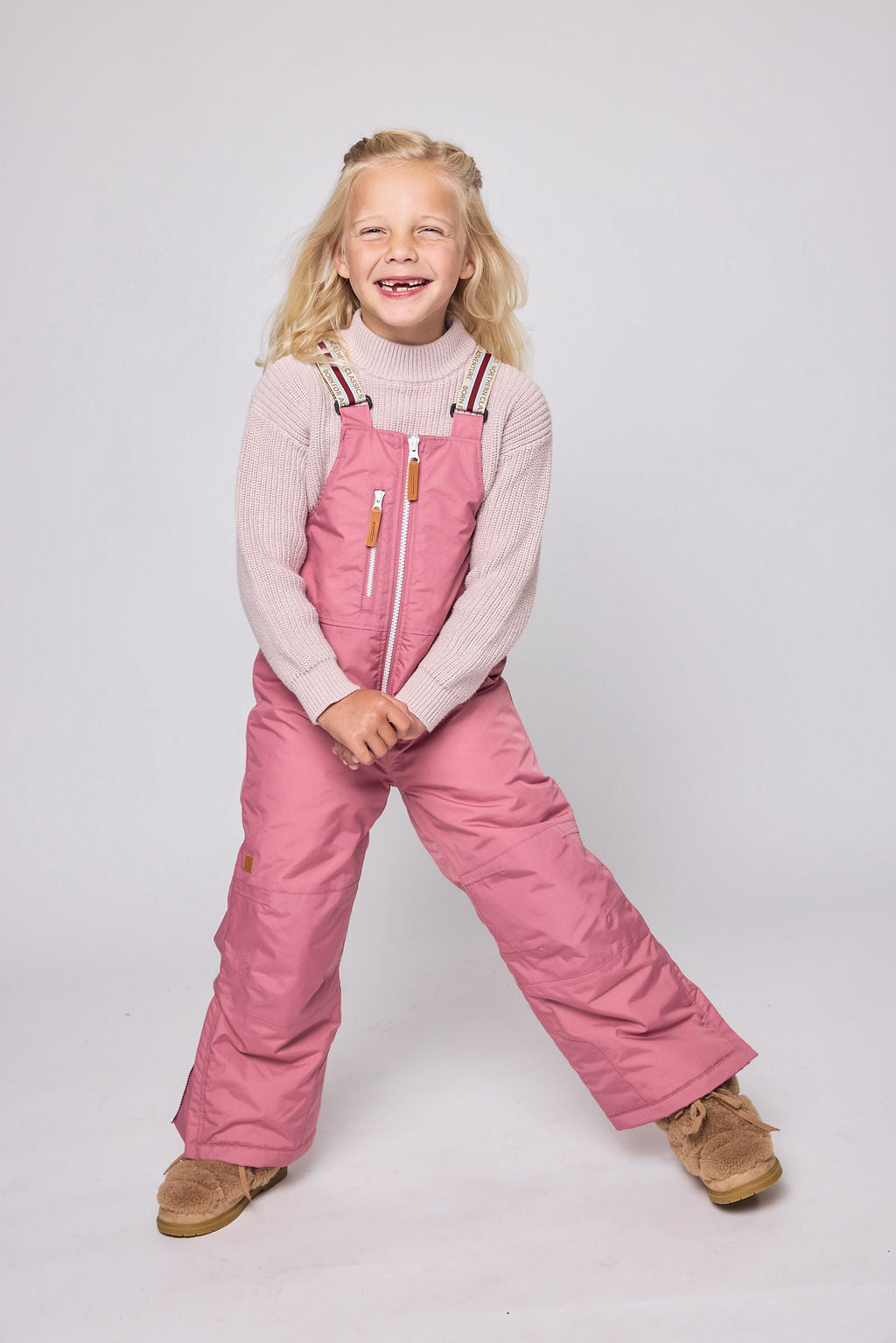Kids pink snow bib pants with adjustable straps, waterproof fabric, and reinforced knees for winter play and ski for girls