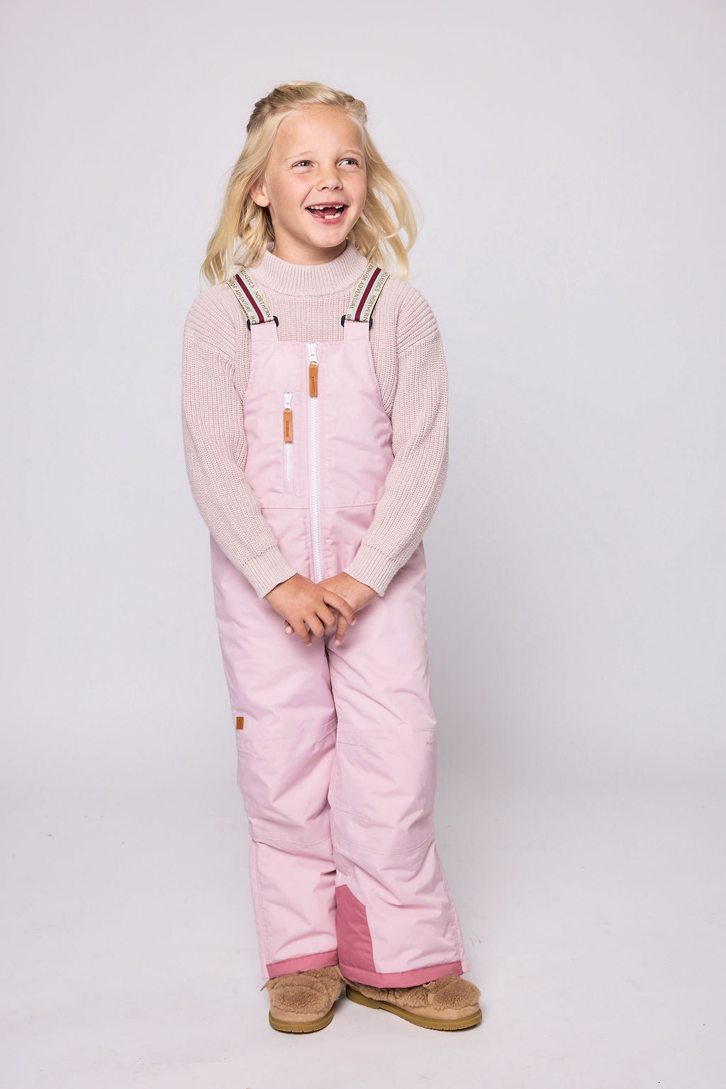 Kids light pink snow bib pants with adjustable straps, waterproof fabric, and reinforced knees for winter play and ski for girls