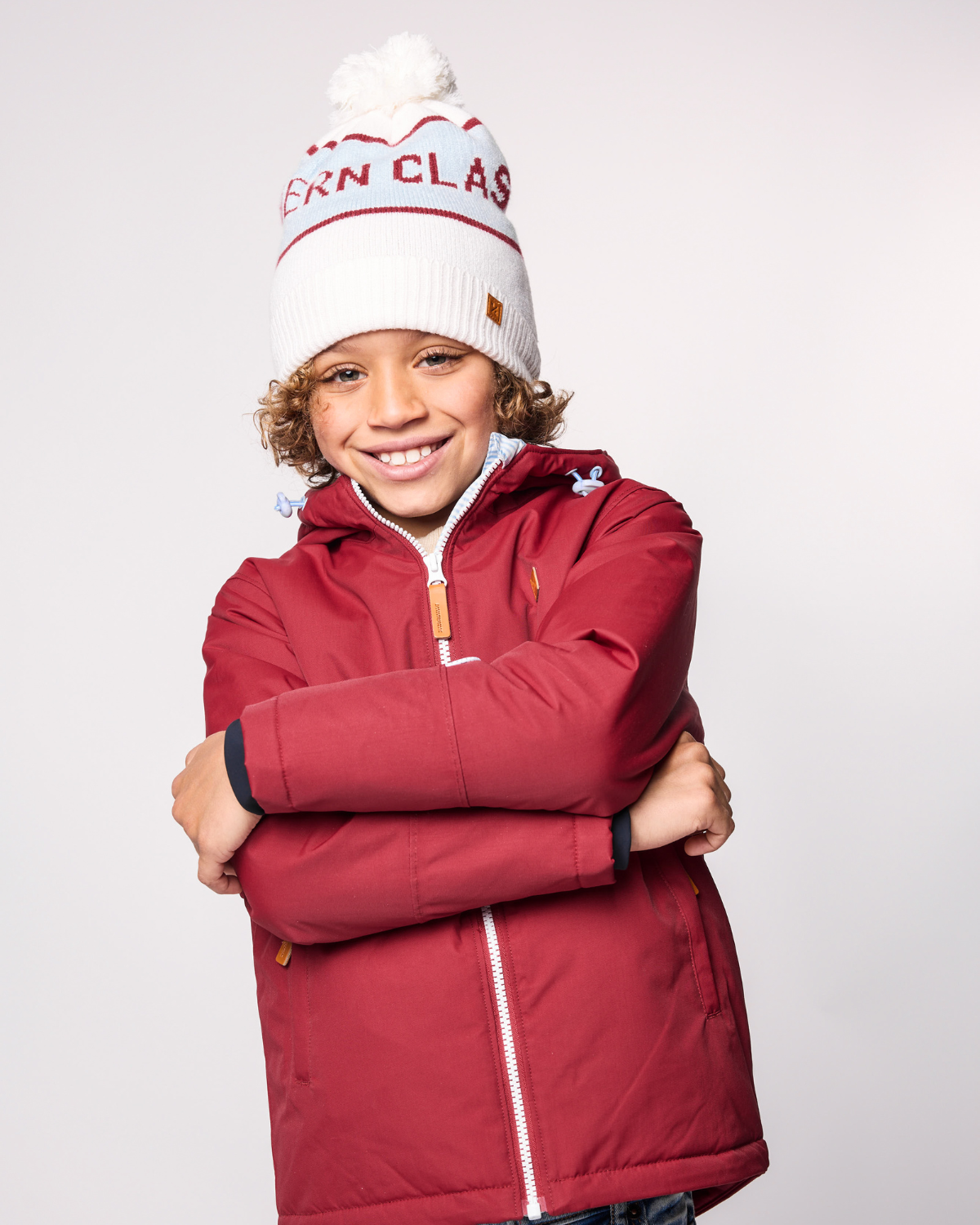 Classic Knit Pom Pom Hat for Kids and Women’s sizes in white, red, and light blue, crafted with soft knit fabric, luxe faux fur pom detail, and winter-ready durability for everyday adventures. It's so soft it feels like cashmere.