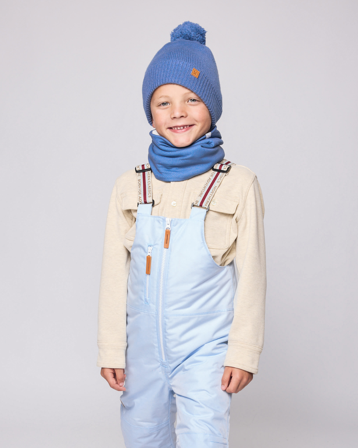 Kids and women's blue fleece neck warmer for boys and girls, made with soft, breathable fabric to keep necks warm during outdoor play, skiing, and winter snow activities