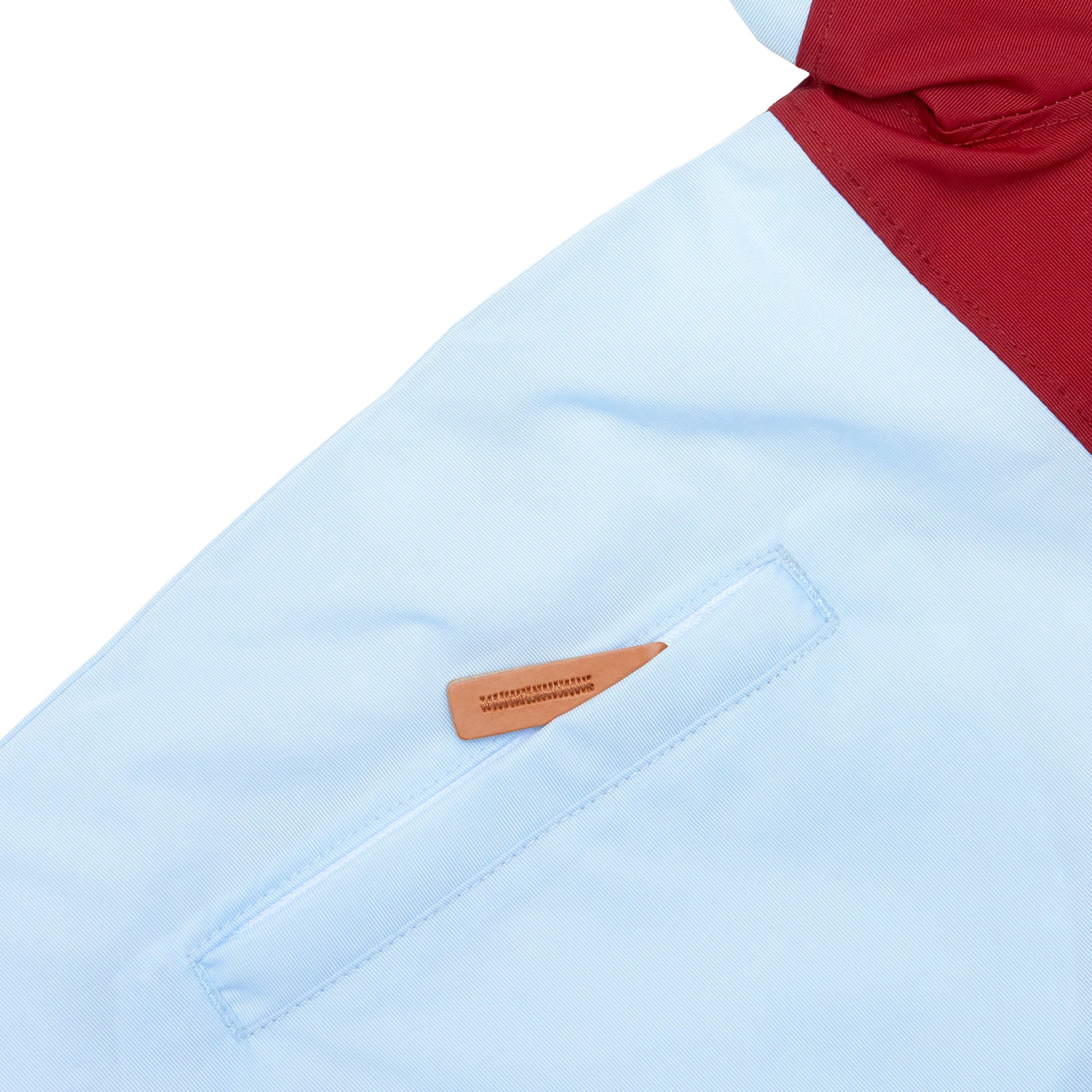Kids red and light blue winter coat for skiing and snow play, with warm insulation and waterproof outer shell for full cold weather protection and hood