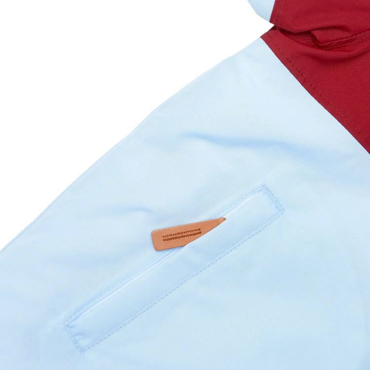 Kids red and light blue winter coat for skiing and snow play, with warm insulation and waterproof outer shell for full cold weather protection and hood