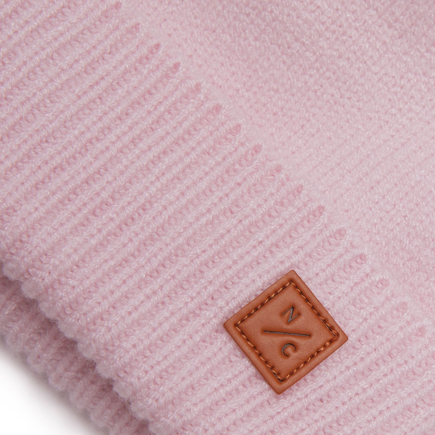 Classic Knit Pom Pom Hat for Kids and Women’s sizes in light pink crafted with soft knit fabric, luxe faux fur pom detail, and winter-ready durability for everyday adventures. It's so soft it feels like cashmere.