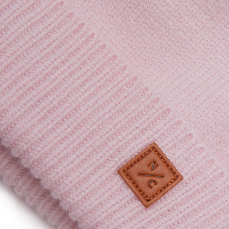 Classic Knit Pom Pom Hat for Kids and Women’s sizes in light pink crafted with soft knit fabric, luxe faux fur pom detail, and winter-ready durability for everyday adventures. It's so soft it feels like cashmere.