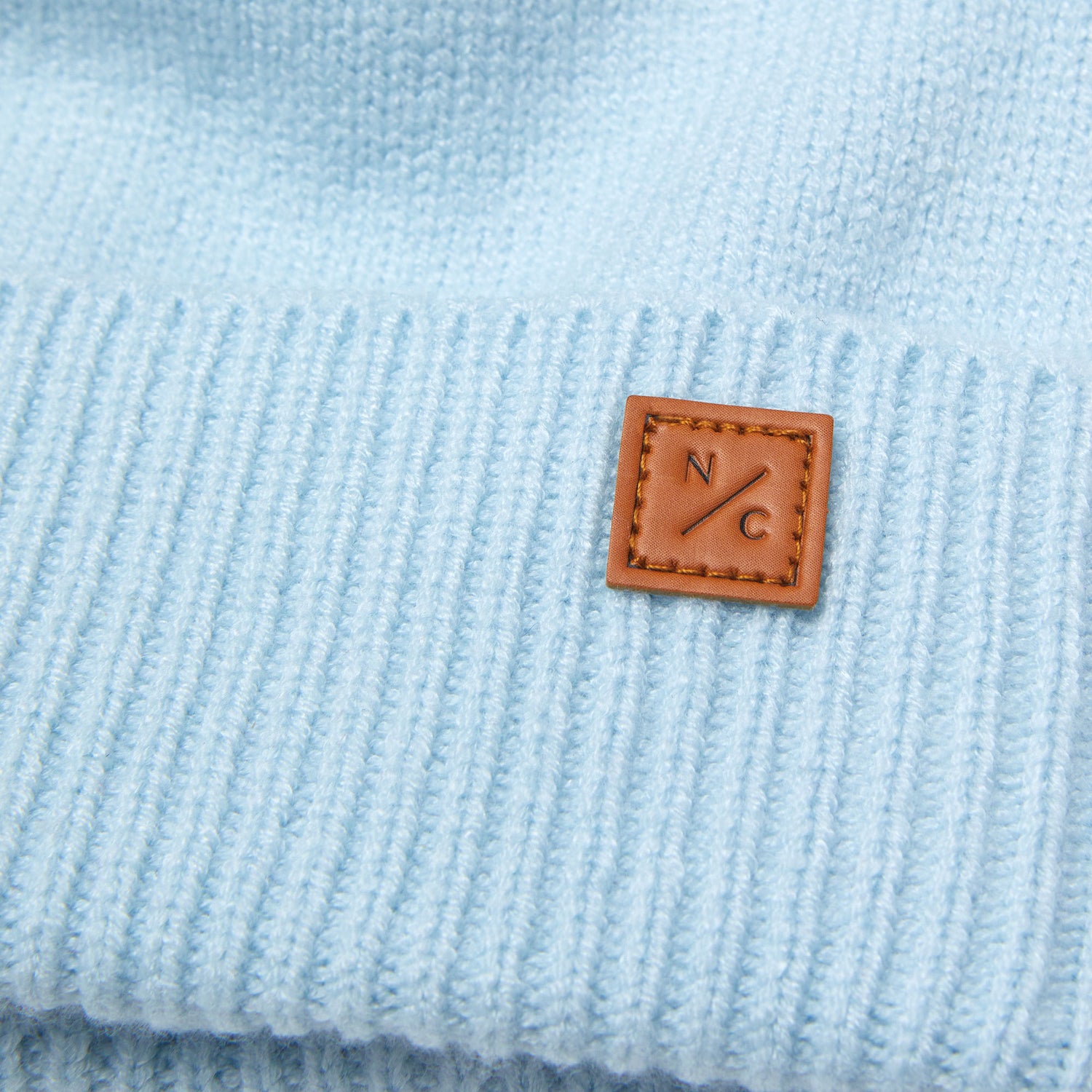 Classic Knit Pom Pom Hat for Kids and Women’s sizes in light blue crafted with soft knit fabric, luxe faux fur pom detail, and winter-ready durability for everyday adventures. It's so soft it feels like cashmere.