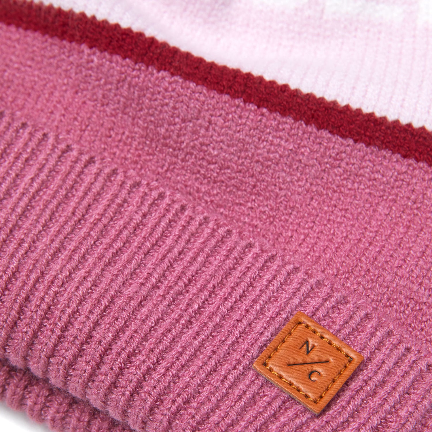 Classic Knit Pom Pom Hat for Kids and Women’s sizes in rose pink, light pink, and red, crafted with soft knit fabric, luxe faux fur pom detail, and winter-ready durability for everyday adventures. It's so soft it feels like cashmere.