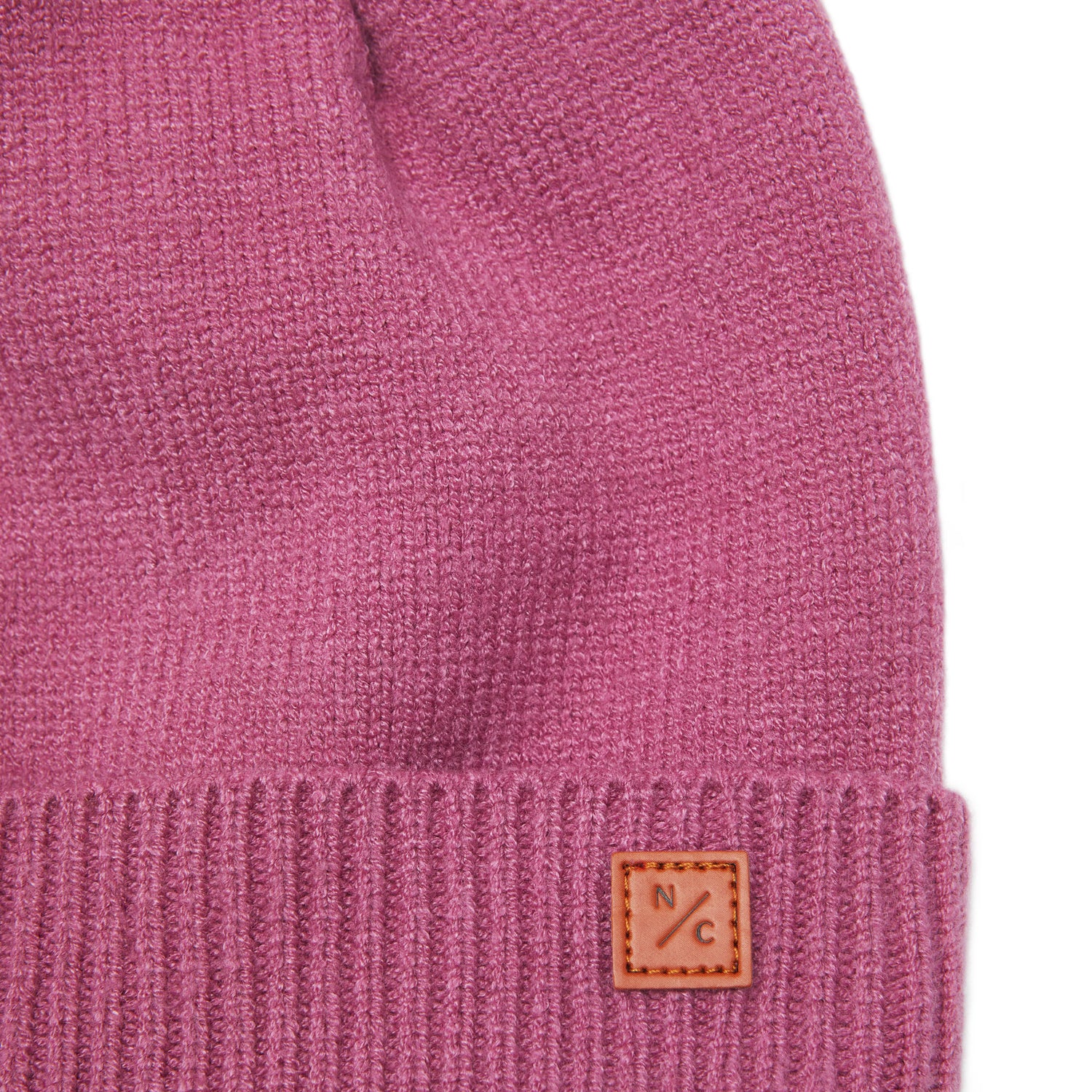 Classic Knit Pom Pom Hat for Kids and Women’s sizes in rose pink crafted with soft knit fabric, luxe faux fur pom detail, and winter-ready durability for everyday adventures. It's so soft it feels like cashmere.