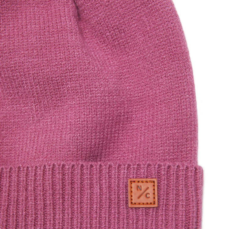 Classic Knit Pom Pom Hat for Kids and Women’s sizes in rose pink crafted with soft knit fabric, luxe faux fur pom detail, and winter-ready durability for everyday adventures. It's so soft it feels like cashmere.