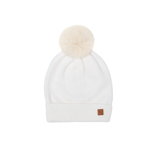 Classic Knit Pom Pom Hat for Kids and Women’s sizes in beige white crafted with soft knit fabric, luxe faux fur pom detail, and winter-ready durability for everyday adventures. It's so soft it feels like cashmere.