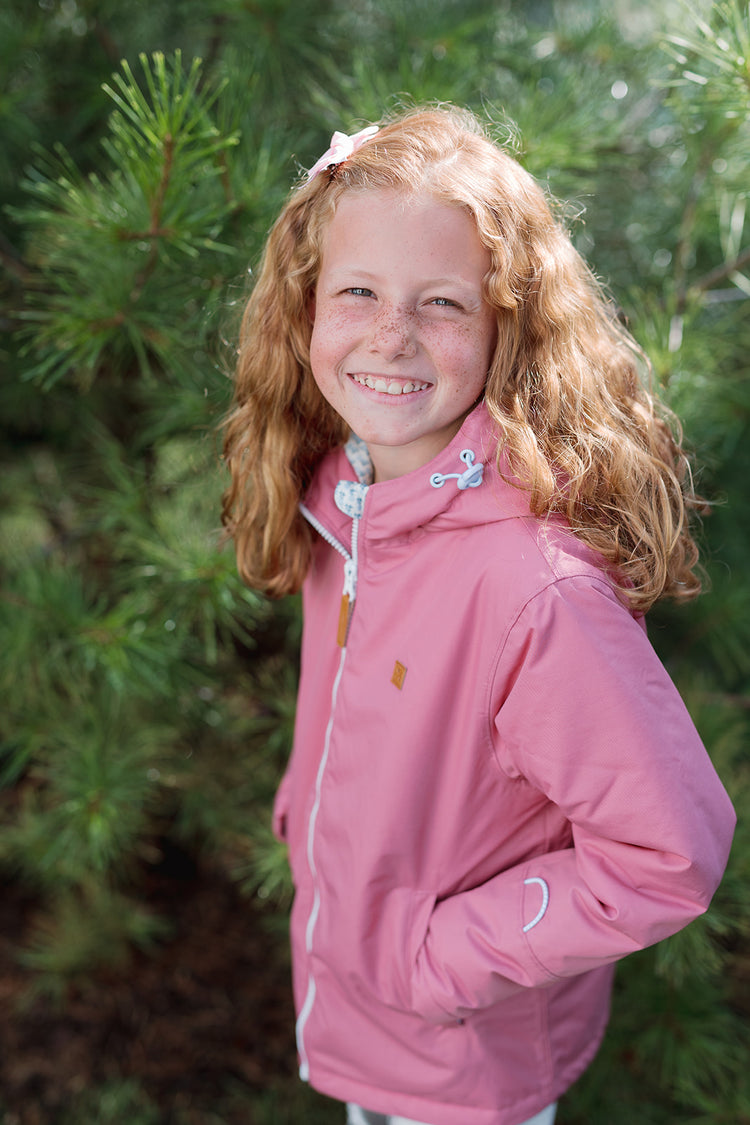 Girls pink winter coat for skiing and snow play, with warm insulation and waterproof outer shell for full cold weather protection and hood
